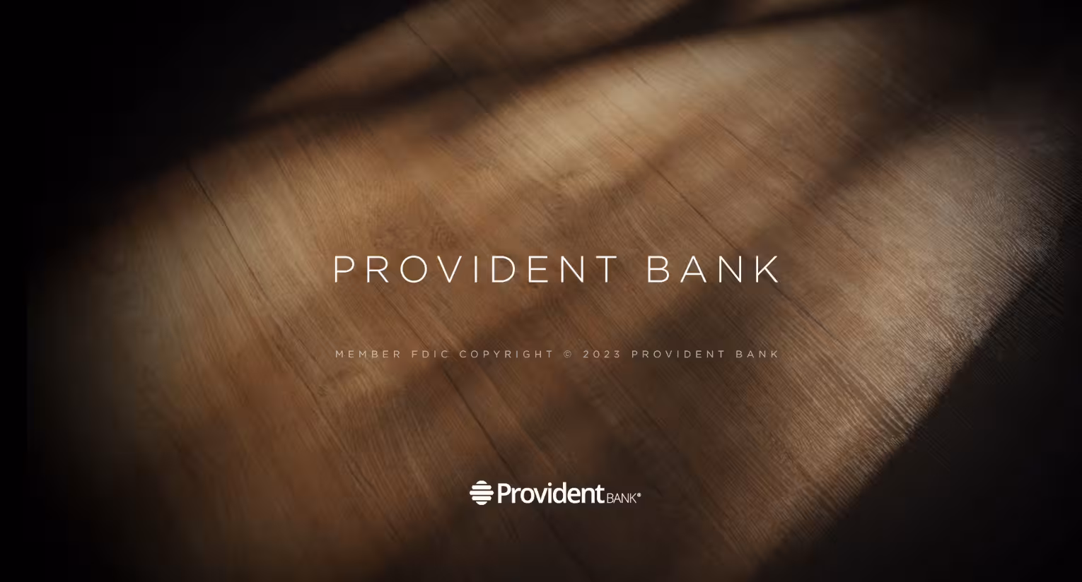Warm light casting across a wooden surface with the words “Provident Bank” centered on the image.
