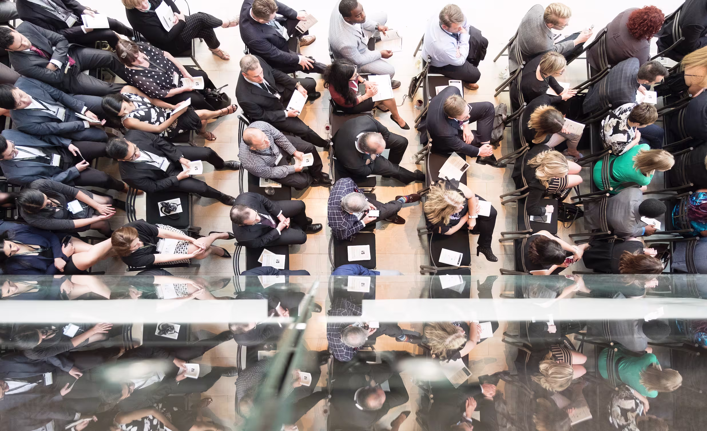 Overhead view of a seated audience arranged in rows during a formal event.